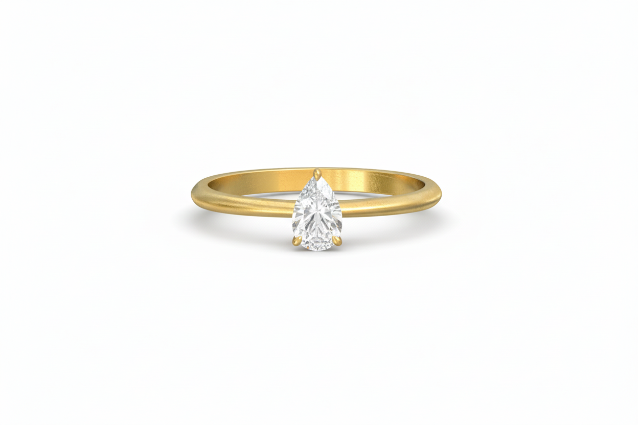 Gold ring with a pear-shaped diamond on a white background