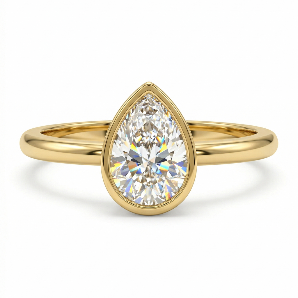 Gold ring with a pear-shaped diamond on a white background