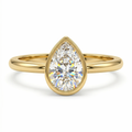 Gold ring with a pear-shaped diamond on a white background