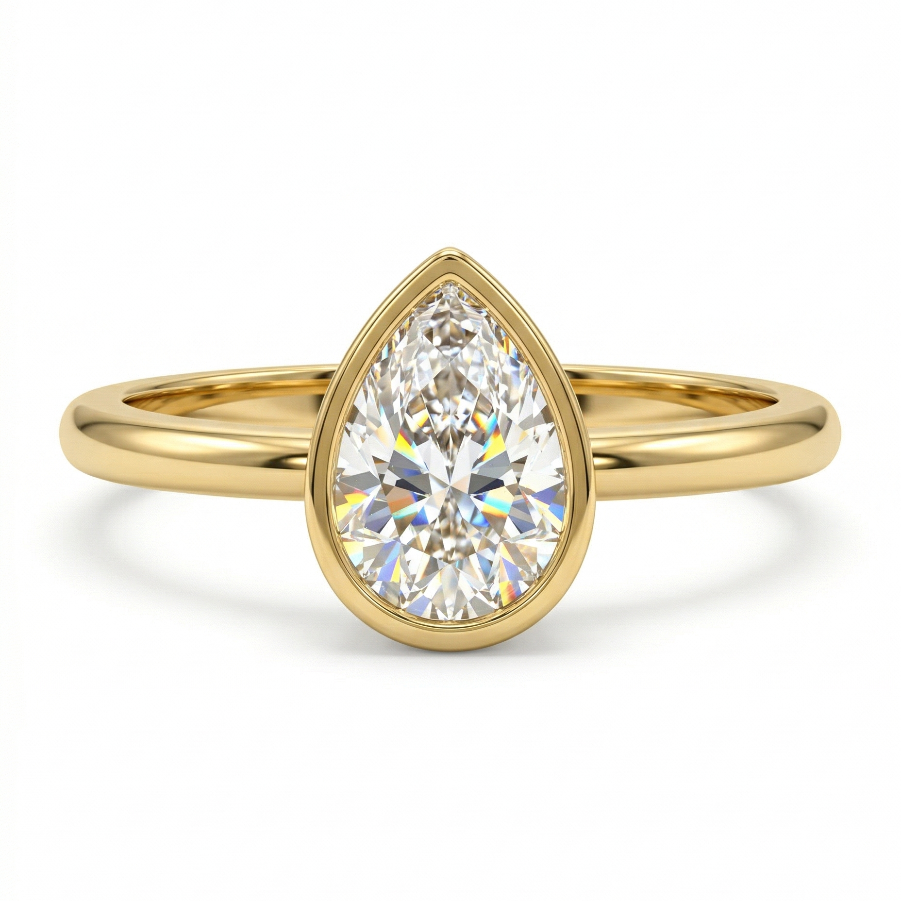 Gold ring with a pear-shaped diamond on a white background