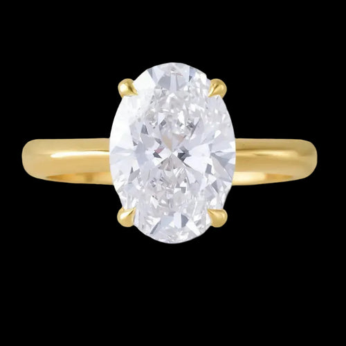 Gold ring with a large oval diamond on a black background