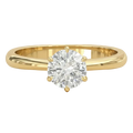 Gold ring with a diamond on a white background