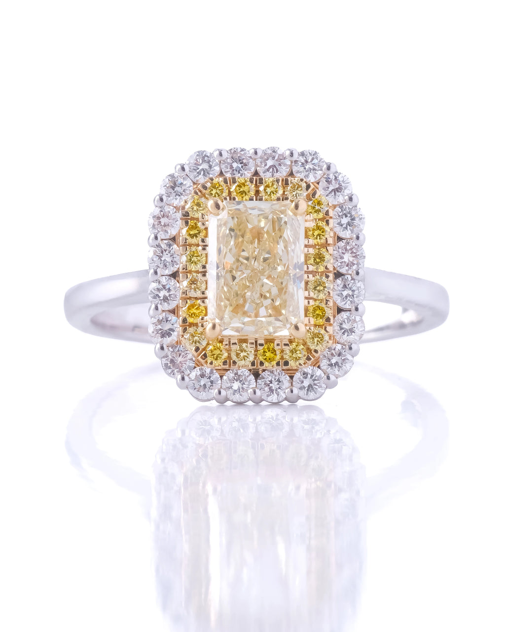 Diamond ring with a yellow center stone on a white background