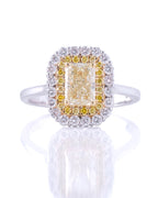 Diamond ring with a yellow center stone on a white background